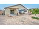 Enjoy this home's backyard with a covered patio, table and chairs, and minimal landscaping at 12425 N 127Th Dr, El Mirage, AZ 85335