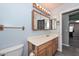 A charming bathroom with a wooden framed mirror, sink vanity, and a toilet at 12425 N 127Th Dr, El Mirage, AZ 85335