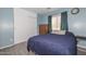 Charming bedroom featuring a closet, bed, and a window with natural light at 12425 N 127Th Dr, El Mirage, AZ 85335