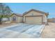 Exterior view of this home showing the garage, driveway, and low maintenance landscaping at 12425 N 127Th Dr, El Mirage, AZ 85335
