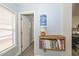 A hallway featuring a water cooler sitting on a wooden shelf filled with books at 12425 N 127Th Dr, El Mirage, AZ 85335