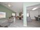 Open-concept living room with gray floors connecting to the kitchen and office space at 12425 N 127Th Dr, El Mirage, AZ 85335