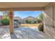 View of a landscaped backyard with a concrete patio and stainless steel gas grill at 12607 W Highland Ave, Litchfield Park, AZ 85340