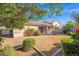A view of the backyard from a distance with a concrete patio, stainless steel grill and desert landscaping at 12607 W Highland Ave, Litchfield Park, AZ 85340