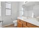 Bright bathroom has a large window, tiled floor, vanity, and toilet at 12607 W Highland Ave, Litchfield Park, AZ 85340