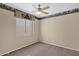 Bedroom has neutral carpet, ceiling fan, and wallpaper border at 12607 W Highland Ave, Litchfield Park, AZ 85340