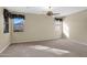 This large bedroom offers dual windows and a ceiling fan for added comfort at 12607 W Highland Ave, Litchfield Park, AZ 85340