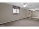 Bedroom boasts neutral carpet, ceiling fan, and mirrored wall at 12607 W Highland Ave, Litchfield Park, AZ 85340