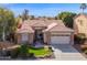 Charming single-story home boasts a well-manicured front yard and attached two-car garage in a residential neighborhood at 12607 W Highland Ave, Litchfield Park, AZ 85340