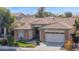 Single-story home featuring a well-manicured front yard, a tile roof, and an attached garage at 12607 W Highland Ave, Litchfield Park, AZ 85340