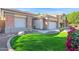 Landscaped front yard with healthy green lawn and attractive plantings creating beautiful curb appeal at 12607 W Highland Ave, Litchfield Park, AZ 85340