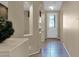 The hallway leads to the decorative front door and is brightly lit by natural light at 12607 W Highland Ave, Litchfield Park, AZ 85340
