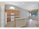 Bright kitchen with white appliances, ample cabinets, and a breakfast bar with convenient sink at 12607 W Highland Ave, Litchfield Park, AZ 85340