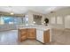 Kitchen with island and ample storage flows into the adjacent living area with lots of natural light at 12607 W Highland Ave, Litchfield Park, AZ 85340