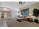 Comfortable living room featuring neutral tones, natural lighting, and seamless flow to kitchen at 12607 W Highland Ave, Litchfield Park, AZ 85340