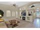 Open-concept living room offers fireplace, large television, and seamless flow to tiled hall at 12607 W Highland Ave, Litchfield Park, AZ 85340