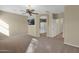 Spacious primary bedroom with en-suite bathroom, TV, and ceiling fan at 12607 W Highland Ave, Litchfield Park, AZ 85340