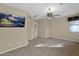 This primary bedroom includes an installed television and a ceiling fan at 12607 W Highland Ave, Litchfield Park, AZ 85340