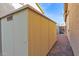 A backyard storage shed on gravel with a light-colored exterior and a simple door and vent at 12607 W Highland Ave, Litchfield Park, AZ 85340