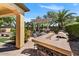 Backyard featuring a covered patio, outdoor seating, kitchen area, and a large grill at 12970 W Kokopelli Dr, Peoria, AZ 85383