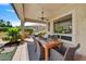 Covered patio featuring dining table, ceiling fan, and pillars with views of the landscaped yard at 12970 W Kokopelli Dr, Peoria, AZ 85383