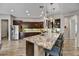 Beautiful kitchen with an island, granite counters, stainless steel appliances and pendant lights at 12970 W Kokopelli Dr, Peoria, AZ 85383