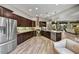 Spacious kitchen with granite counters, stainless steel appliances, and wood look tile at 12970 W Kokopelli Dr, Peoria, AZ 85383