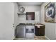 The laundry room has a sink and modern front load machines at 12970 W Kokopelli Dr, Peoria, AZ 85383