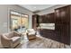 Bright seating area boasts dark wood cabinets, and outdoor access to the patio at 12970 W Kokopelli Dr, Peoria, AZ 85383