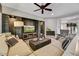 Comfortable living room with a stone accent wall, large sectional and a ceiling fan at 12970 W Kokopelli Dr, Peoria, AZ 85383