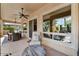 Comfortable patio with ceiling fans, lounge chair, and outdoor dining area with backyard views at 12970 W Kokopelli Dr, Peoria, AZ 85383