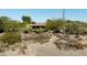 Scenic view of the property nestled in the desert landscape with native plants and rock formations at 1301 Coyote Pass, Carefree, AZ 85377