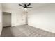 A bright bedroom with neutral carpet, ceiling fan, and ample closet space at 14402 N 34Th Ave, Phoenix, AZ 85053