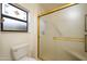 Bathroom featuring a frosted glass shower, decorative glass window and standard white toilet at 14534 W Yosemite Dr, Sun City West, AZ 85375