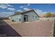 View of the back of the home and desert rock landscaping at 14815 S Padres Rd, Arizona City, AZ 85123