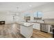 Bright open kitchen with island, stainless steel appliances, and an adjacent living area at 1653 W Morelos St, Chandler, AZ 85224