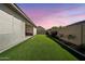 Beautiful backyard with lush green synthetic lawn, providing a serene outdoor living space at 17165 W Piperton St # 181, Surprise, AZ 85388