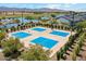 Aerial view of a well-maintained outdoor basketball court with multiple blue-surfaced playing areas at 17165 W Piperton St # 181, Surprise, AZ 85388