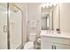 Bright bathroom featuring a glass-enclosed shower, white vanity, and modern fixtures at 17165 W Piperton St # 181, Surprise, AZ 85388