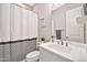 Cozy bathroom features a shower/tub combo, white cabinets and a decorative mirror at 17165 W Piperton St # 181, Surprise, AZ 85388