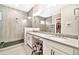 Modern bathroom showcasing a large vanity with dual sinks and a glass-enclosed shower at 17165 W Piperton St # 181, Surprise, AZ 85388