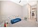 Playroom with blue fold out sofa, built in shelving and carpeted floor at 17165 W Piperton St # 181, Surprise, AZ 85388