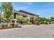 A view of the attractive and well-maintained clubhouse, featuring ample parking and landscaping at 17165 W Piperton St # 181, Surprise, AZ 85388