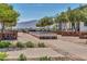 Community area showcasing outdoor seating, brick accents, lush landscaping, and mountain views at 17165 W Piperton St # 181, Surprise, AZ 85388