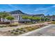 Scenic view of community buildings with well-maintained landscaping, sidewalks, and charming architectural details at 17165 W Piperton St # 181, Surprise, AZ 85388