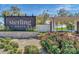 Welcoming community sign with colorful flowers and attractive landscaping at 17165 W Piperton St # 181, Surprise, AZ 85388