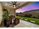 A cozy covered patio with outdoor seating and ceiling fan offers a relaxing outdoor living space at 17165 W Piperton St # 181, Surprise, AZ 85388