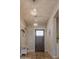 Inviting entryway with elegant chandeliers, stylish decor, and a modern coat rack with bench at 17165 W Piperton St # 181, Surprise, AZ 85388