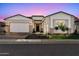 Charming single-story home featuring a manicured front yard, stone accents, and a two-car garage at 17165 W Piperton St # 181, Surprise, AZ 85388