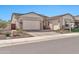 Attractive one-story home with a well-manicured front yard, desert landscaping, and a two-car garage at 17165 W Piperton St # 181, Surprise, AZ 85388